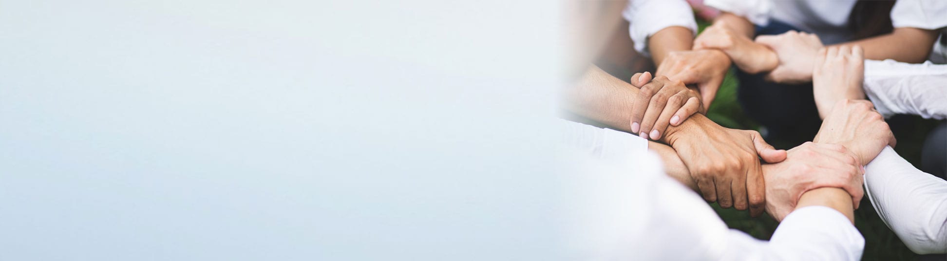 Community Engagement carousel image. Hands interlocking